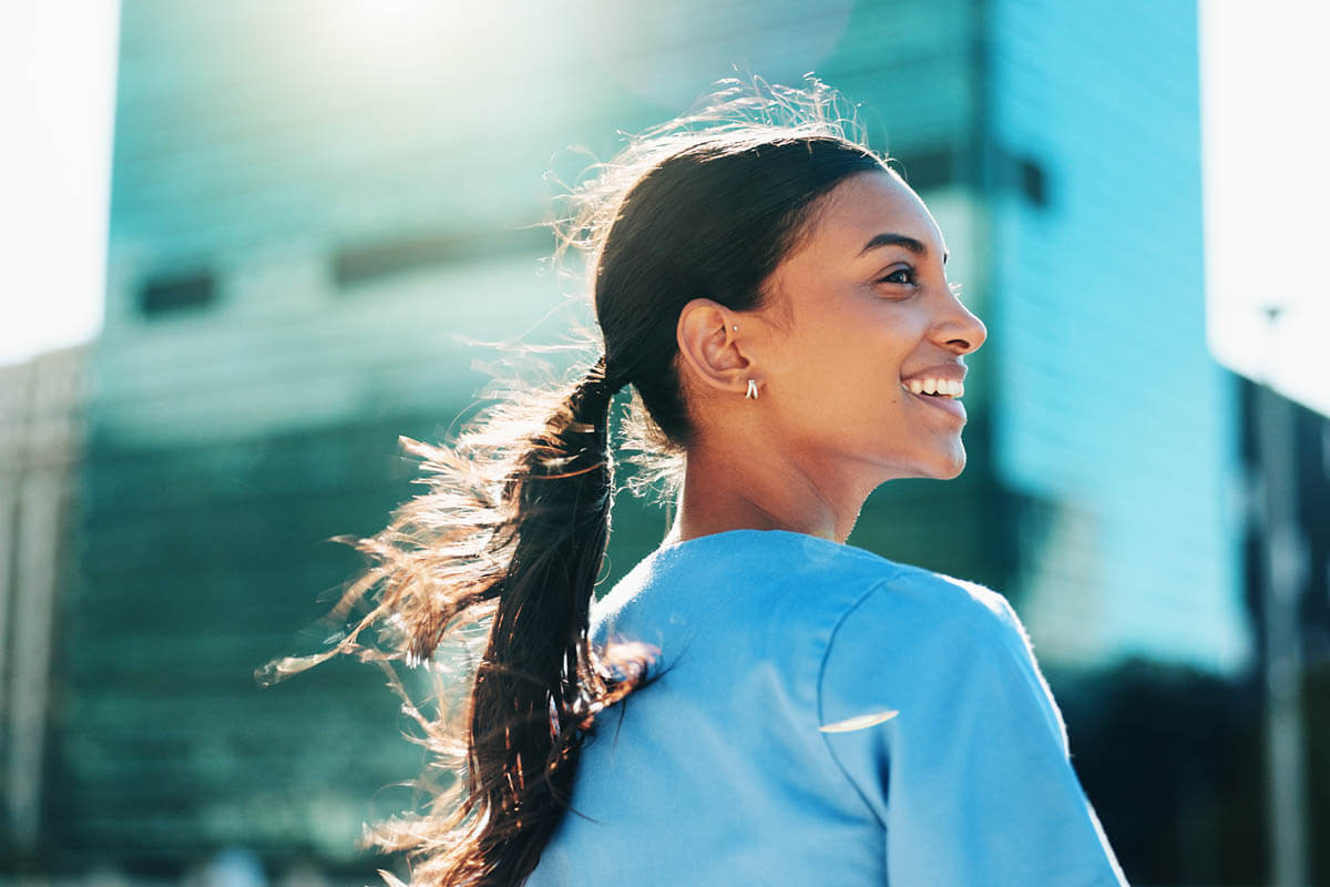 Photo of a nurse walking outside a building